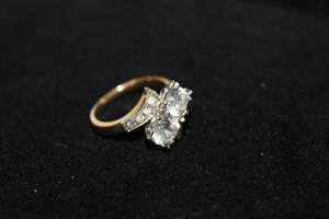 lot 343 image: 14K two tone yellow and white gold ring with White Topaz center stones (tested). Marked 14K. Size 5.5