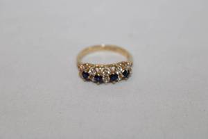lot 373 image: 14K yellow gold dark blue Spinel and white stone ring. Marked 14K DQ CZ (QVC Designer Quality). Size 7. Dark stones tested as Spinel but please verify at preview.