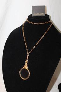 lot 397 image: Signed Joan Rivers Classics magnifying glass lorgnette on 32L chain w barrel clasp and hang tag. With logo storage pouch and booklet. Overall length 20L.