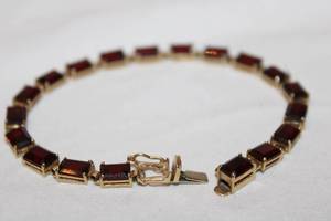 lot 365 image: 14K yellow gold 19-carat emerald cut signed Garnet bracelet. Marked 14K ADPG (Albert David). Garnets tested. 7.75L (missing one Garnet)