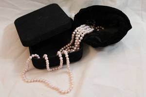 lot 418 image: Cultured opera length continuous button pearl strand 60L. With storage pouch and box. Great condition.