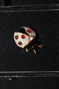 lot 405 image: Signed Joan Rivers enamel, crystal and pave lady bug pin in logo box