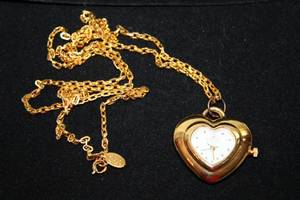 lot 403 image: Signed Joan Rivers quartz hanging watch pendant with 1 diamond marker on a 28L gold tone chain. Marked with hang tag and on watch.