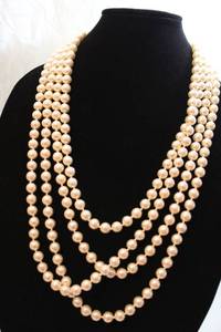 lot 398 image: Signed Joan Rivers Classics 60L faux opera pearl strand. Barrell clasp and hang tag. In logo box with logo pouch and booklet