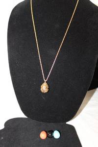 lot 400 image: Signed Joan Rivers Classics Collection QVC gold tone caged egg pendant frame necklace with (3) interchangeable eggs and logo hang tag. 30L One of her most famous pieces.