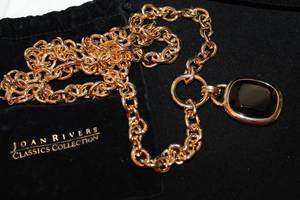 lot 401 image: Signed Joan Rivers Classics gold tone 2 Amethyst Crystal square fixed pendant on 34L chain. Marked on back of pendant. In logo storage pouch.