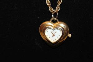 lot 406 image: Signed Joan Rivers quartz watch pendant with diamond marker on a 30L gold tone chain. Has jewelry hang tag.