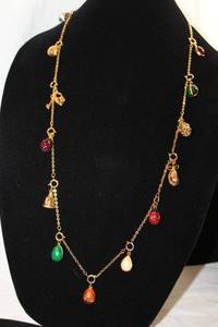 lot 409 image: Signed Joan Rivers enamel egg charm necklace. All charms can be removed or new ones added, One of her most iconic pieces from her collection. Has jewelry hang tag. Presently 32L