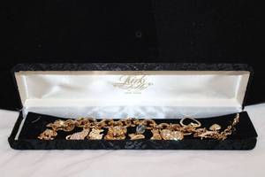 lot 412 image: Signed Kirks Folly charm bracelet in box. Marked Kirks Folly in original box