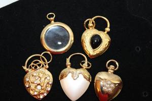 lot 414 image: (5) detachable necklace pendants. (4) in heart form and magnifying glass. Likely Kirks Folly but no marks