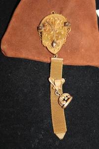 lot 425 image: Intricate antique Victorian (likely 12K Gold Filled) mourning hair locket with hinged bale and ribboned fob seal . Reverse has glass enclosed compartment for hair  worn near heart ...to keep loved ones close to our hearts. Unmarked