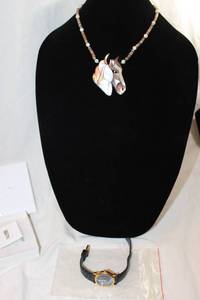 lot 437 image: Lee Sands branded jewelry. Includes leather quartz watch and iconic shell necklace with horse form Paua shell pendant in original box.