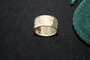 lot 469 image: Sterling Silver Irish band ring with Celtic symbols. Made in Ireland. Marked JMH 925 Made In Ireland. Size 8. Designed by Michael Hilliard. In box w storage pouch and information booklet.