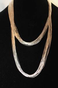 lot 474 image: Sterling Silver Heishi liquid silver bead (20) multi strand necklace. Marked Sterling 3 places. A whopping 52L