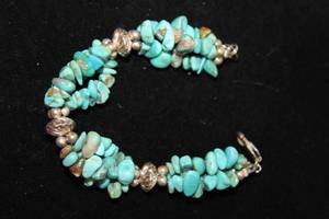 lot 458 image: Sterling Silver Southwest Traditions branded (authentic Kingman) Turquoise triple strand bracelet. Marked 925. 7L w information sheet.