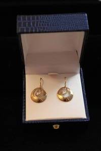 lot 445 image: 14K yellow gold French ear wire earrings with CZ dancing dangles. Marked JCM 14K CZ. In push button gift box. Approx 1L