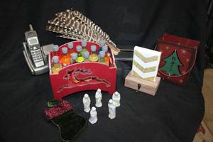 lot 258 image: Christmas home dcor ceramic nativity figures, stocking hanger, metal sack votive holder, red wooden reindeer box with cocktail mixes, cordless phone and feathers