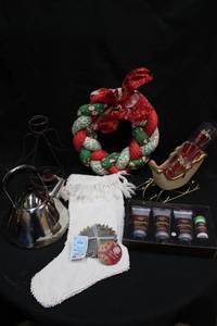 lot 114 image: Holiday housewares fabric braided wreath, white stocking, wire angel taper holder, chrome tea kettle, lotionsoap set