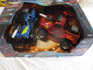 lot 74 image: NIB-2-Battle Machines, Laser Combat RC Trucks-Complete