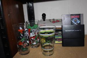 lot 85 image: NES Advantage Controller as Well as an assortment of Game Cartridges and Retroport adapter and some Collectable Drinking Glasses.
