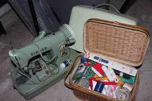 lot 88 image: Vintage Singer Sewing Machine. still in good working condition,with cover for storage and port Along with a very Generous Amount of Sewing Supplies
