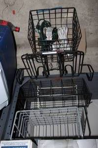 lot 98 image: Misc.wire baskets and racks, one under cabinet rack, and home extention cords as shown