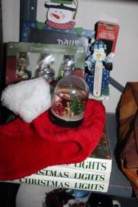 lot 106 image: Christmas Home Decor, with Christmas string lights, snow globes and other Christmas Penguin items