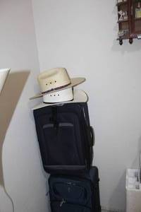 lot 222 image: 2 White Cowboy Hats and 2 Suitcases On Wheels
