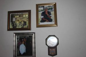 lot 171 image: Celebrity Photos.  Autographed Platters Picture (Authenticity unknown),   A Tiger Woods Picture,  A Photo of Morgan Freeman at a Social Gathering, and a Wall Clock