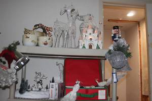 lot 230 image: Beautiful Lighted White Christmas Castle, Nutcracker, White Santa, 12 Days before Christmas Cookie Jar and 4 Bowls, White Sparkling Reindeer and Ice Skating Rink with Skaters, Variety of Orgnaments and Lights