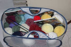 lot 234 image: Basket Full of Yarn and Crochet Hooks, Books on how to