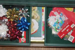 lot 277 image: Tub Full of Wrapping Paper, Gift Boxes, Tissue Paper, Gift Bags, Bows, and Tags.