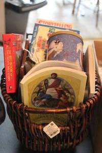 lot 415 image: Wicker Basket and childrens books, along with a decorative metal sliegh