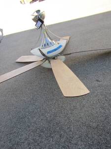 lot 100 image: Livingroom or dinning room ceiling fan plus light, used needs a new bulb, was replaced with new still works good, also comes with a working remote.