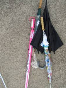 lot 139 image: Lot of umbrellas, new and used one is a news paper print