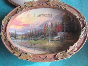lot 4 image: Thomas Kinkade wall plaques with saying Tranquility, Harmony and Serenity, all 3 are 75 and have a wooden frame around them