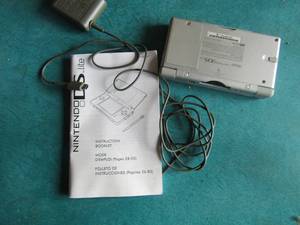 lot 5 image: Nintendo DS lite, comes with charger and paper work, unknown working condition
