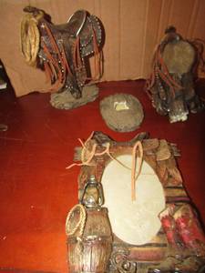 lot 23 image: Western saddle dcor, one broken but piece is included, 57 western picture frame