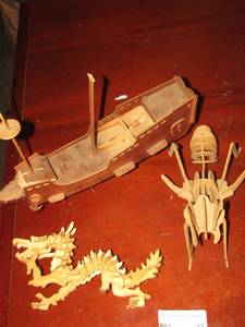 lot 33 image: Hand crafted wooden dragon, wooden ant, wooden sail boat