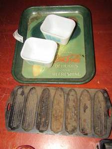lot 53 image: Blue on white rooster corning butter dish qty 2, Cast iron 7 slot corn cob cornbread maker, vintage coca cola metal tray