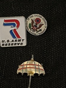 lot 71 image: 4 pins- 1 U.S. Army Reserve, 1 Mouse, umbrella, 1 U.S .Embassy of Ottawa and 1 rustic handmade ring