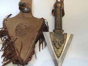 lot 4 image: Indian inspired knife with eagle head both sides. Blade 4,5 on with total 8.5. Made in China in leather tool sheath