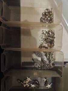 lot 227 image: a massive amount of small charms of assorted types- skulls, wings, stars, guitars and rings.