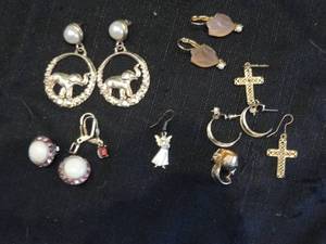 lot 96 image: 7 sets of earrings- crosses, elephants, hoops, leaves and 1 single angel earring
