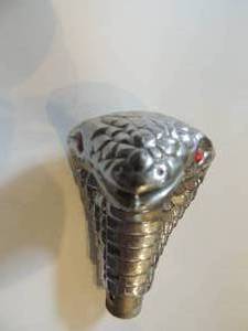 lot 63 image: Silver cobra head with red glass eyes can be used for can topper or maybe shift stick