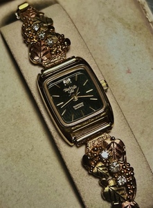 lot 1 image: Vintage Black Hills Gold&nbspC.CO&nbspColeman Ladies Watch 10k Gold LEAF Diamond Quartz WAdditional Six Stones Added to Band $$
