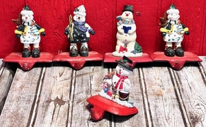 lot 89 image: Five Vintage Cast Iron Base Snowmen Mantle Stocking Hangers