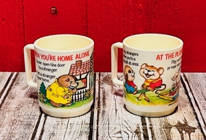 lot 297 image: Two (2)Vintage 1985 Deka Plastics At the Playground &amp At Home Instructional Child Safety Mugs