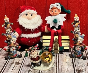 lot 366 image: Santa Snow Globe,Snow Men Totems, Stocking Holders, Along With Santa and an Elf