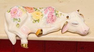 lot 372 image: Ceramic Bisque SleepingShelf Sitter Floral Cow Figure With Gold Trim - Signed By Artist - Marlene A96